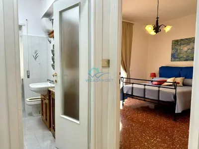 a bathroom with a bed and a sink in a room at Typical Grandma's Roman Apartment in Rome