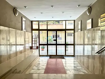 a hallway with a large glass door in a building at Typical Grandma's Roman Apartment in Rome