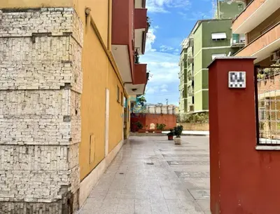 an empty street in a city with buildings at Typical Grandma's Roman Apartment in Rome