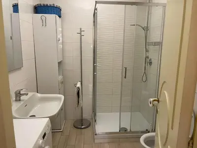 a bathroom with a shower and a sink at Charming Apartment Near Roman Forum - 60 m² in Rome