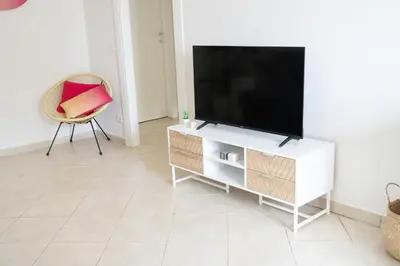 a living room with a television and a chair at Vatican 4 BedRoom Apartment with Private Parking in Rome