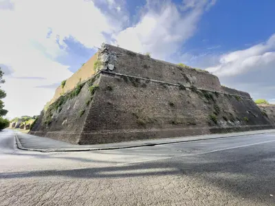 an old wall on the side of a road at Unique Garden Apartment near Caracalla Baths in Rome