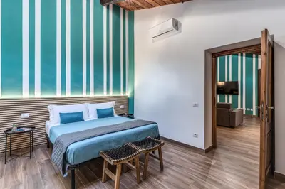 a bedroom with a bed and a large window at Luciana Vatican Apartment in Rome