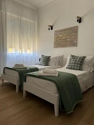 two beds sitting in a room with at Casa Palmiero in Rome