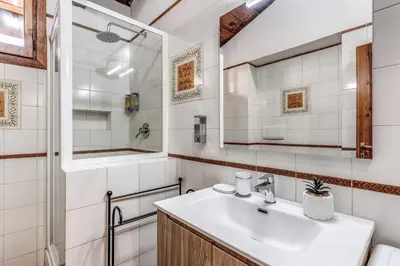 a bathroom with a sink and a mirror at Elena Vatican Apartment in Rome