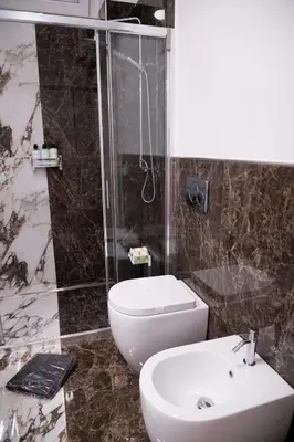 a bathroom with a toilet and a shower and a sink at Antonella in Rome