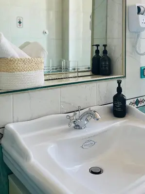 a white sink in a bathroom with a mirror at Casa Roma San Giovanni in Rome