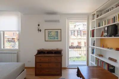 a bedroom with a bed and a desk and a book shelf at Valeria Terrace - Monti, Rome in Rome