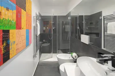 a bathroom with two sinks and a shower and a toilet at Valeria Terrace - Monti, Rome in Rome