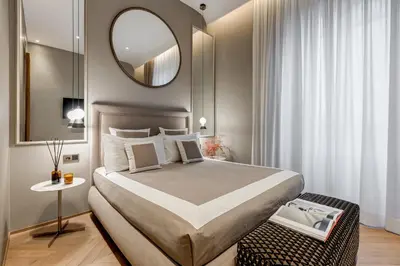 a bedroom with a large bed and a mirror at BDC - Luxurylifestyle in Rome