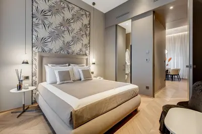 a bedroom with a large bed and a chair at BDC - Luxurylifestyle in Rome