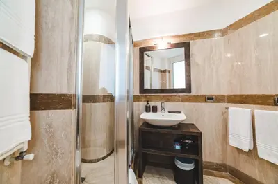 a bathroom with a sink and a mirror at Elegant Apartment Vallombrosa 55 in Rome