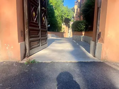 a shadow of a person standing in front of a door at Elegant Apartment Vallombrosa 55 in Rome