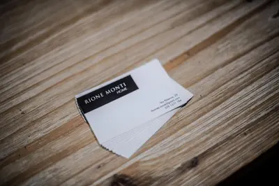 a piece of paper sitting on top of a wooden table at Rione Monti Home in Rome