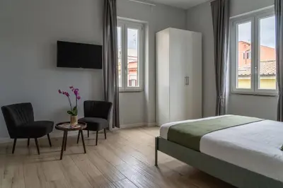 a bedroom with a bed and two chairs and a table at Pigneto Apartment VaDo al Pigneto Collection in Rome