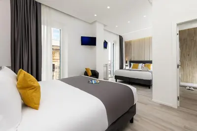 a hotel room with two beds and a large window at St Peter Twelve in Rome