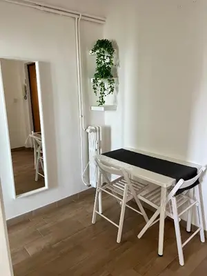 a table and chairs in a room with a mirror at Il Cielo Su Roma San Paolo in Rome