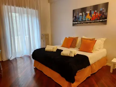 a bedroom with a large bed with orange pillows at Monti Parioli de Charme in Rome