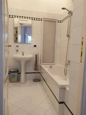 a white bathroom with a sink and a shower at Monti Parioli de Charme in Rome