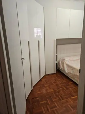 a room with white cabinets and a bed in it at La Casa di Fede in Rome