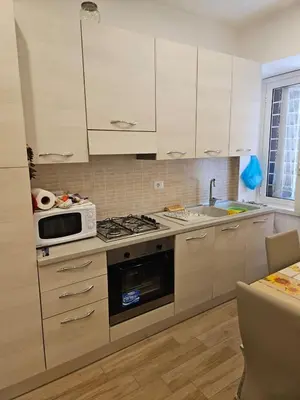 a kitchen with a microwave and a stove top oven at La Casa di Fede in Rome
