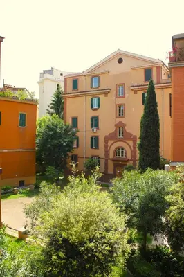 a view of a building with trees and bushes at Epirhome, tra Colosseo e Porta Santa in Rome