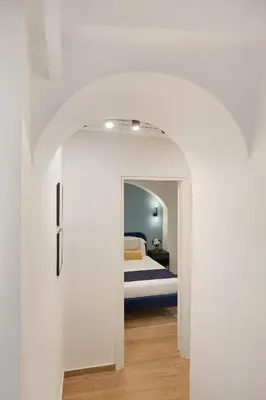 a bedroom with a bed in a white room at Leopardo Boutique Apartment in Trastevere in Rome