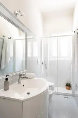 a white bathroom with a sink and a toilet at Vatican Loft - San Pietro in Rome