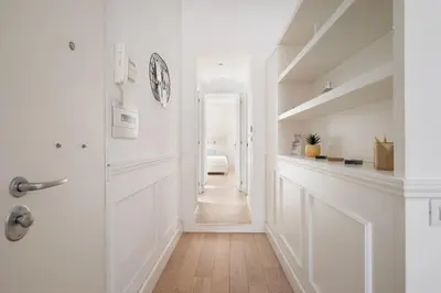 a hallway with white walls and a stairway with a door at Crystal Home Piazza Navona in Rome