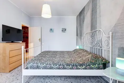 a bedroom with a bed and a tv at The Pope's Oasis near Trastevere and Historical Center in Rome