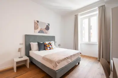 a bedroom with a bed and a window at Elegant Haven Re di Roma by Hostand in Rome