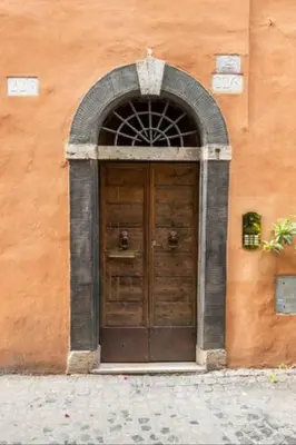 a large wooden door in a building at Navona in Love in Rome