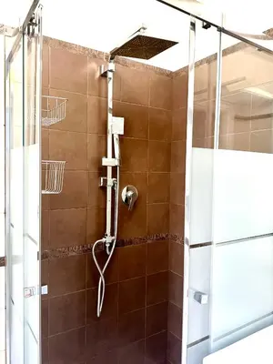 a shower with a glass door in a bathroom at Olimpia Bis - Gianicolo - Trastevere - Vaticano - Centro Storico di Roma in Rome