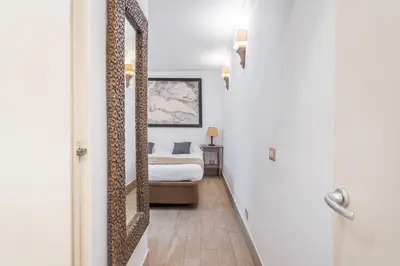 a bedroom with a bed and a mirror at Flaminio Garden, Indenpent Flat 10 min from the City Center in Rome
