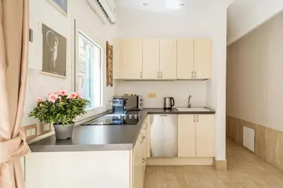 a kitchen with white cabinets and a counter top at Flaminio Garden, Indenpent Flat 10 min from the City Center in Rome