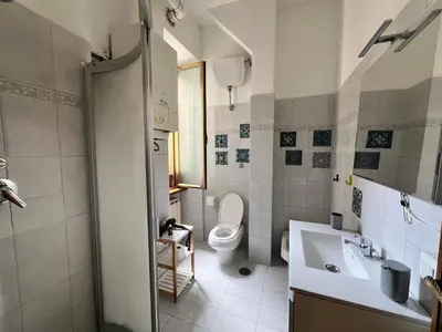 a bathroom with a toilet and a sink at Home Rome in Rome