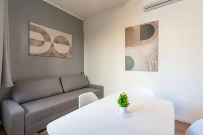 a living room with a couch and a table at Central Modern Apartment - Colosseo 10 min in Rome