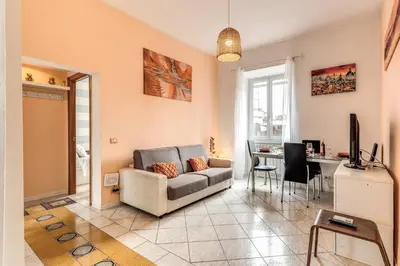 a living room with a couch and a table at Pìgneto Roma Good Vibes Apartment in Rome