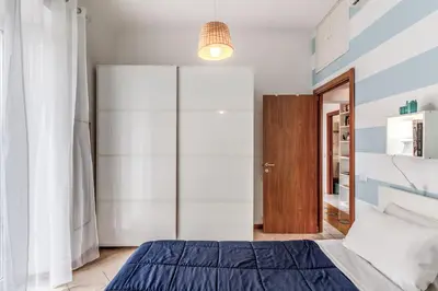 a bedroom with a bed and a glass closet at Pìgneto Roma Good Vibes Apartment in Rome