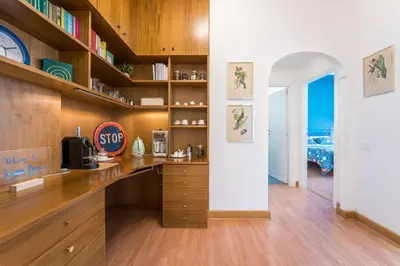 a kitchen with wooden cabinets and a counter top at Flaminio Blues, Cozy Flat Near Piazza del Popolo in Rome