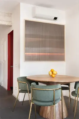 a dining room with a wooden table and green chairs at Vatican Loft - Musei Vaticani in Rome