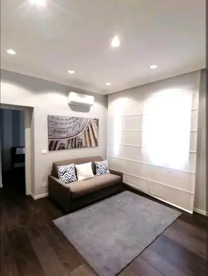 a living room with a couch and a large window at Piazza di Spagna Suite in Rome
