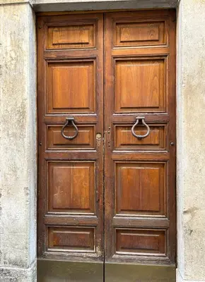 a pair of wooden doors on a building at Lovely apartment in the center of Rome, Monti in Rome