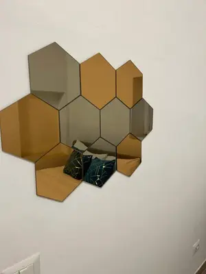 a wall mounted mirror with three pillows on a wall at Lovely apartment in the center of Rome, Monti in Rome