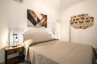 a bedroom with a bed and a painting on the wall at Design Flat - Nel Centro di Roma in Rome
