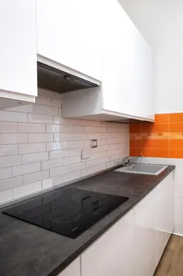 a kitchen with white cabinets and a sink at Washington TownHouse - Roma Statuto in Rome