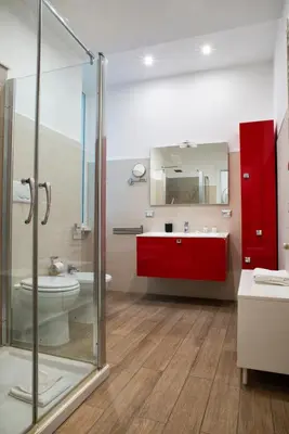 a bathroom with a toilet and a sink and a mirror at Washington TownHouse - Roma Statuto in Rome