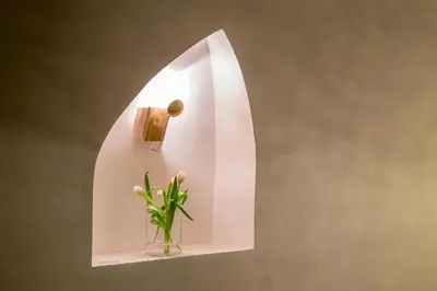 a shelf with a vase with a plant in it at Palazzo De Cupis - Suites and View in Rome