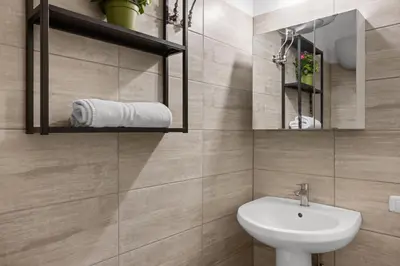 a bathroom with a sink and a mirror at Cavour 172 - Monti Apartment near Colosseum by RHR in Rome
