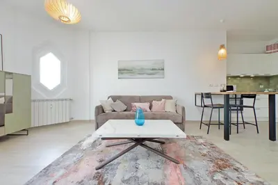 a living room with a couch and a table at YCH-Rifugio incantato sul Tevere in Rome